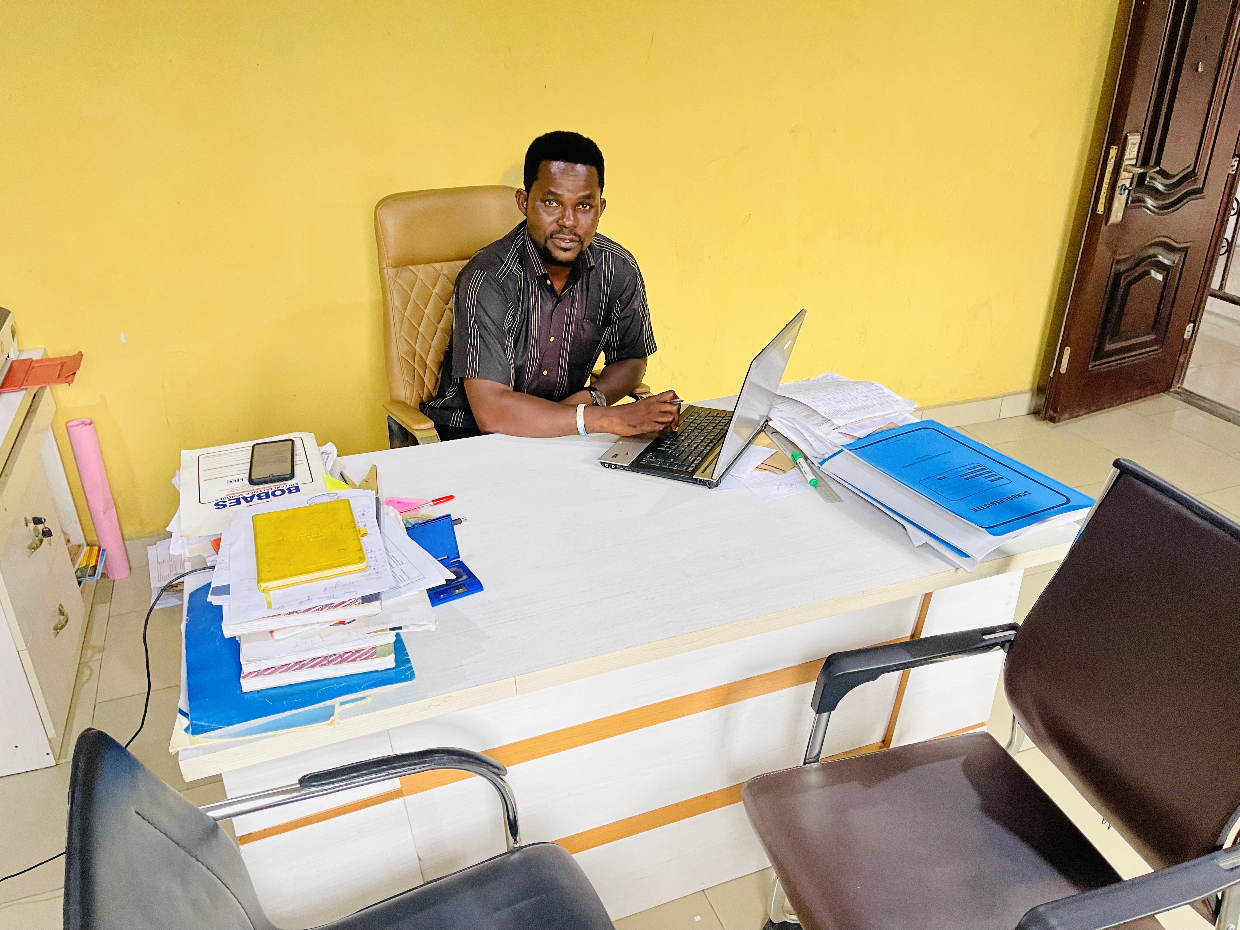 Mr Kelechi Romanus Ukeje seated at his desk