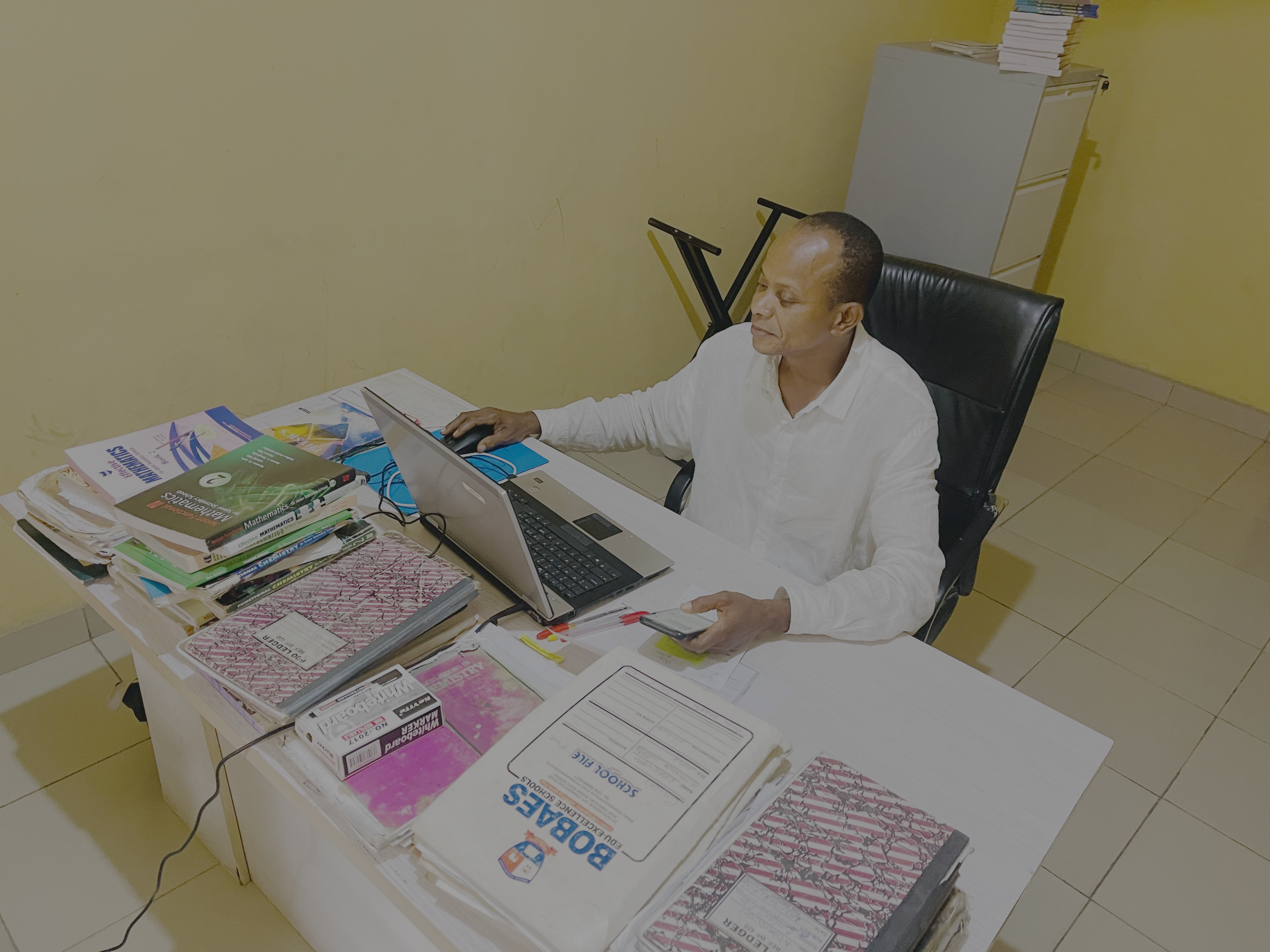 Mr Christopher Chilekwe Nnamdi seated at his desk
